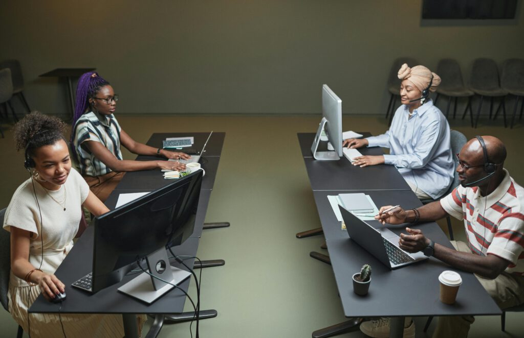 Diverse call center team collaborating in a modern office setting.